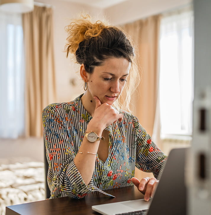 Clinician reviewing documentation on a laptop
