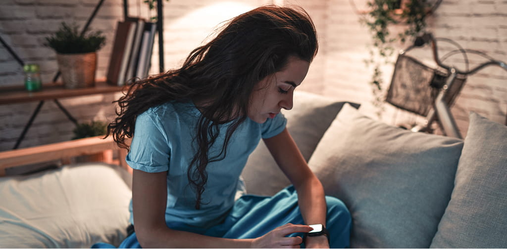 Clinician at a laptop looking fatigued