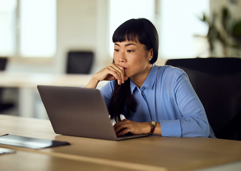 Physical therapist working at a laptop